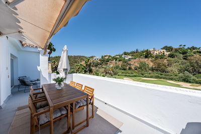 Empty road by building against clear sky
