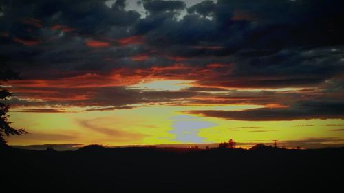 Scenic view of silhouette landscape against sky during sunset