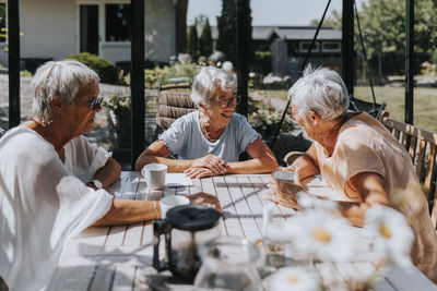 Senior women having coffee together in garden