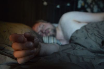 Man sleeping on bed at home