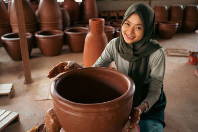 Side view of young woman sitting on table