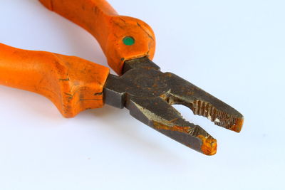 Low angle view of pliers on white background