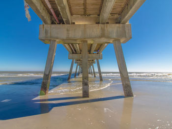Silhouette pier over sea against sky