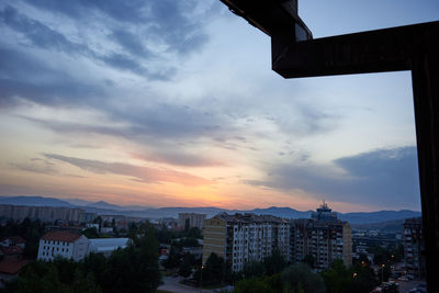 Buildings in city at sunset