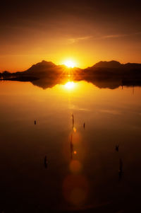 Scenic view of lake against sky during sunset