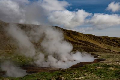 Smoke emitting from volcanic mountain against sky