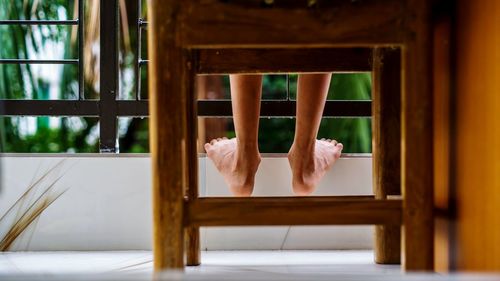 Close-up of woman sitting on bench