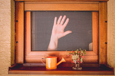 Hand on the window