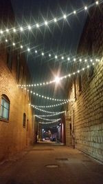 Illuminated tunnel at night