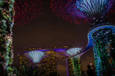 Low angle view of illuminated ferris wheel at night