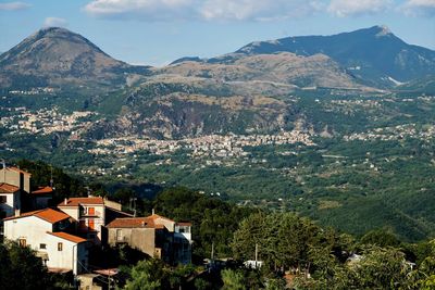 High angle view of townscape and mountains against sky