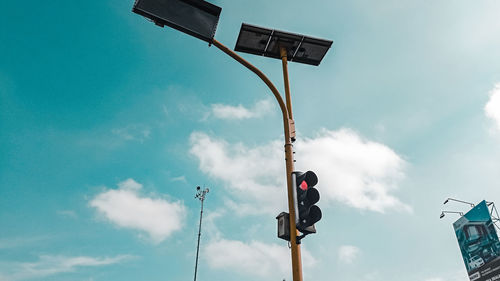 Low angle view of road sign against sky