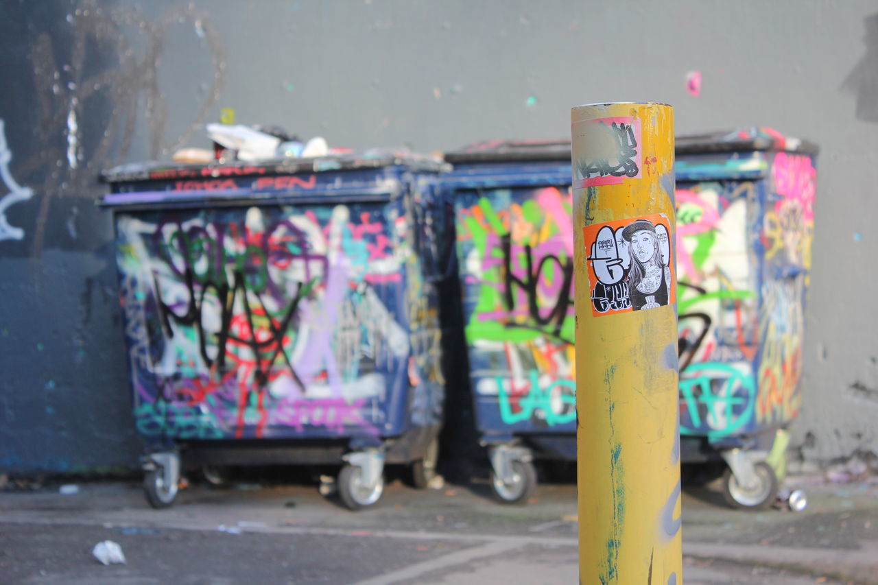 metal, focus on foreground, close-up, padlock, rusty, still life, metallic, day, selective focus, no people, street, hanging, lock, wall - building feature, outdoors, container, old, stationary, yellow