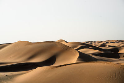 Low angle view of desert against clear sky