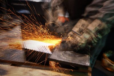 Blurred motion of man welding metal