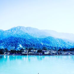 Scenic view of lake and mountains against clear sky
