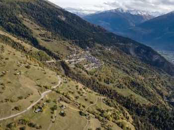 High angle view of land and mountains against sky