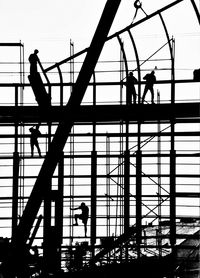 Low angle view of silhouette people against sky