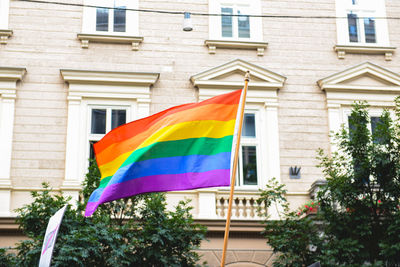 Low angle view of flag against built structure