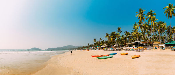 People at beach against sky