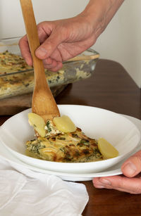 Close-up of person preparing food on table