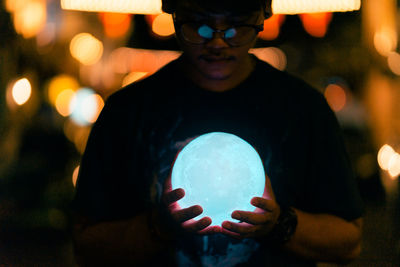 Close-up portrait of man holding ball