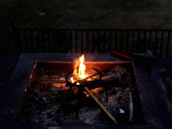 Close-up of bonfire on log at night
