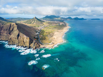 Scenic view of sea and mountains against sky