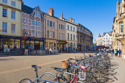 Bicycles parking and shops along street of oxford university