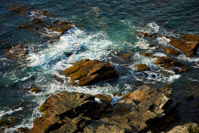 High angle view of rocks in sea