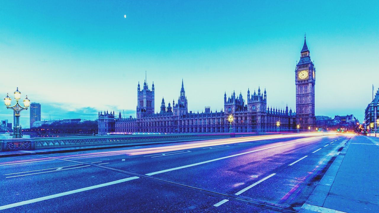 architecture, built structure, building exterior, clear sky, blue, city, transportation, copy space, road, illuminated, tower, road marking, the way forward, capital cities, travel destinations, street, sky, travel, light trail, cityscape