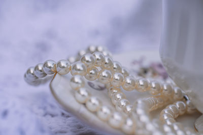Close up of pearls on saucer