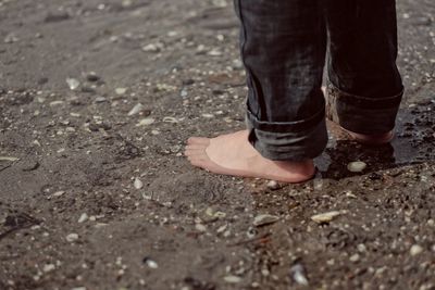 Low section of woman standing on ground