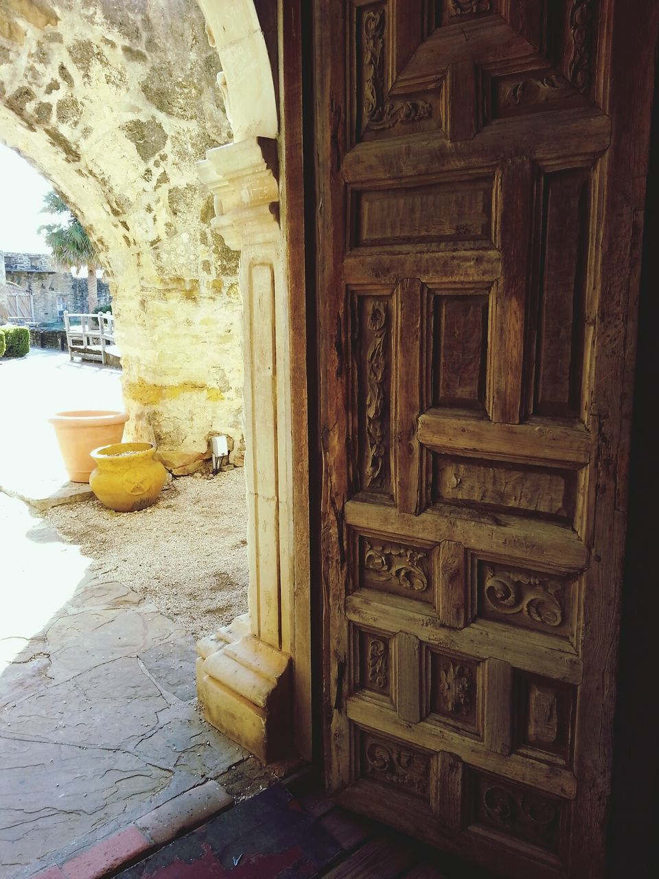 built structure, architecture, indoors, wood - material, building exterior, door, window, religion, place of worship, day, entrance, spirituality, sunlight, old, house, potted plant, no people, home interior, ornate, table