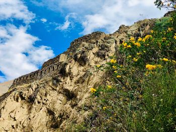 Low angle view of rocky mountain against sky