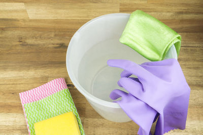 High angle view of cleaning equipment with bucket on hardwood floor