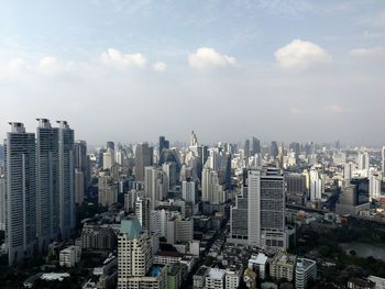 High angle view of modern buildings in city against sky