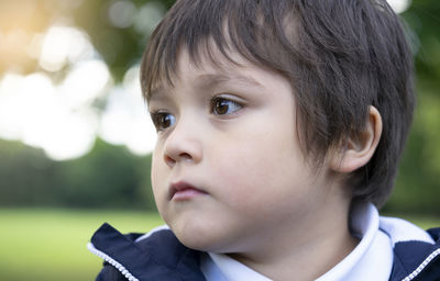 Close-up of cute boy looking away