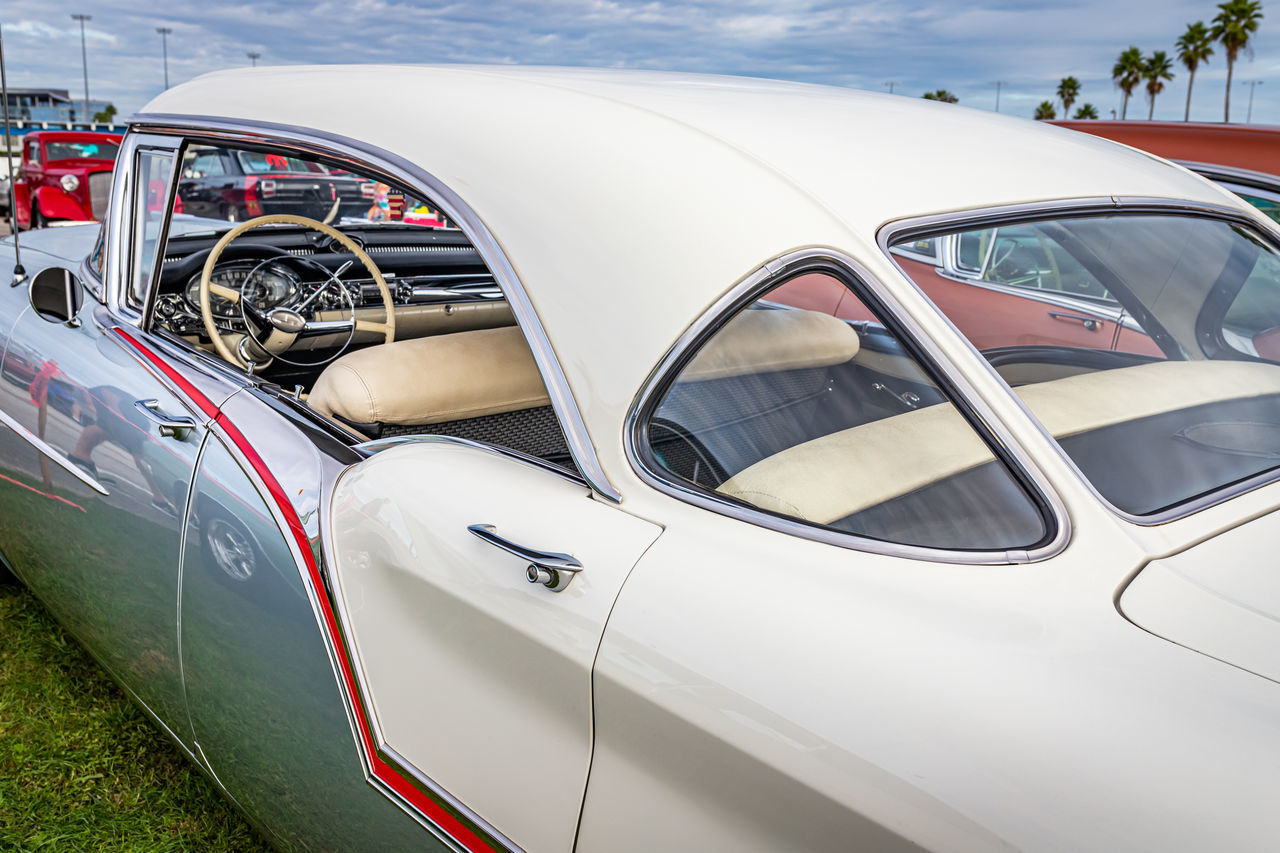 CLOSE-UP OF WHITE CAR ON METAL