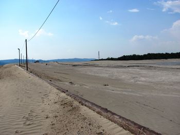 Scenic view of sand against sky