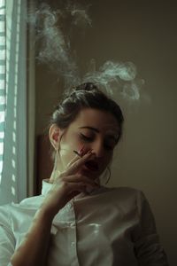 Young woman smoking cigarette