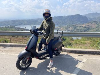 Man riding motorcycle on road