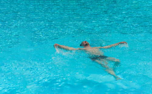 Man swimming in pool