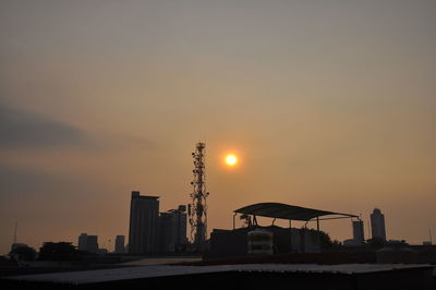 Silhouette buildings against sky during sunset