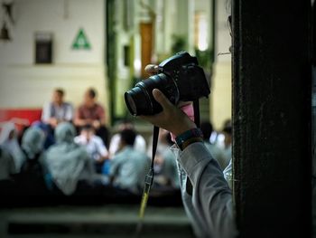 Close-up of photographer holding camera