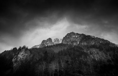 Scenic view of mountains against cloudy sky