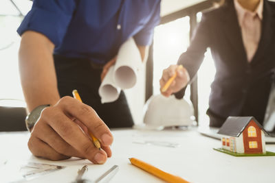 Close-up of people working on table