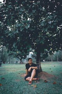 Portrait of man sitting on field