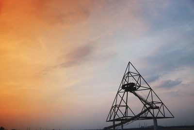 Low angle view of silhouette tower against sky during sunset