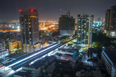 High angle view of illuminated buildings in city at night